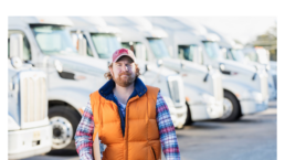 Man standing in front of trucks
