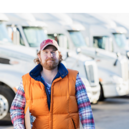 Man standing in front of trucks